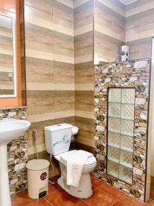 a bathroom with a toilet and a sink at Pimlada in Chiang Mai