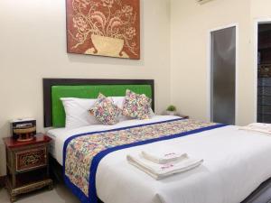a bedroom with a large bed with towels on it at Pimlada in Chiang Mai +105 photos