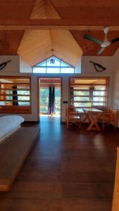 a large room with a bed and a table at DM Farms Morni Hills Panchkula in Morni