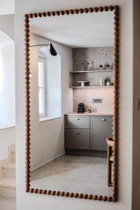 a mirror in a room with a kitchen at Villa Kaleta Brac in Sutivan