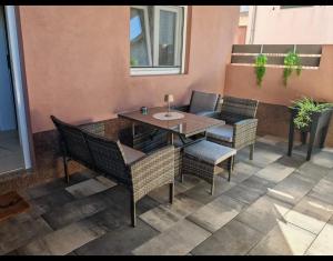a patio with a table and chairs on a balcony at Apartmani Milat in Sveti Filip i Jakov +12 photos