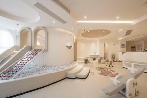 a large waiting room with escalators in a store at Town Designer B&B in Qingdao