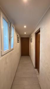 a hallway with a window and a tile floor at Sanella Rooms in Venice