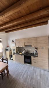a kitchen with wooden cabinets and a stove top oven at Sanella Rooms in Venice