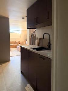 a kitchen with brown cabinets and a white counter top at Timber Cabin By The Ski Slopes In Oppdal in Oppdal +23 photos