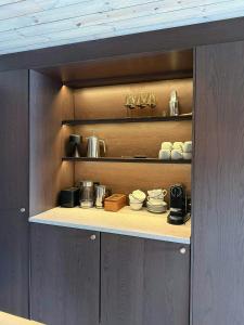 a cupboard with plates and pans on it at Timber Cabin By The Ski Slopes In Oppdal in Oppdal