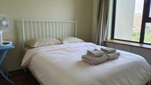 Postel nebo postele na pokoji v ubytování Yuan Apartment
