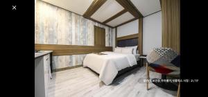 ソウルにあるRamon Hotelのベッドルーム(白いベッド1台、テーブル、椅子付)