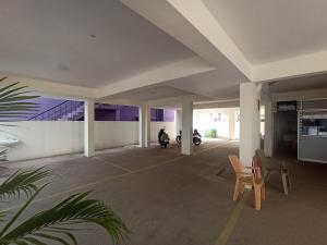 an empty parking lot with a motorcycle in a building at shree service apartment in Madurai