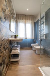 a bathroom with a sink and a toilet and a shower at A CASA di LAURA in Bergamo