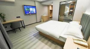Ένα ή περισσότερα κρεβάτια σε δωμάτιο στο GreenTree Inn Taizhou Gaogang District Business Hotel