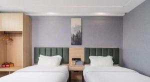 Ένα ή περισσότερα κρεβάτια σε δωμάτιο στο GreenTree Inn Taizhou Gaogang District Business Hotel