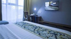 Ένα ή περισσότερα κρεβάτια σε δωμάτιο στο GreenTree Inn Taizhou Gaogang District Business Hotel