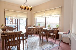 un comedor con mesas, sillas y ventanas en Lal Hotel Bursa, en Bursa