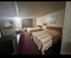 a hotel room with two beds and a window at Circle Inn Hotel - Jurupa Valley Riverside 60 Fwy in Riverside