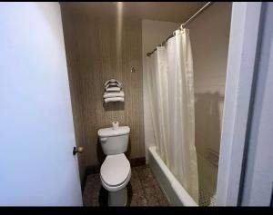 a bathroom with a white toilet and a shower at Circle Inn Hotel - Jurupa Valley Riverside 60 Fwy in Riverside