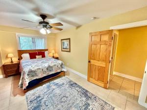 a bedroom with a bed and a ceiling fan at Somehow, Someday, Somewhere, Seaside in St. George Island +38 photos