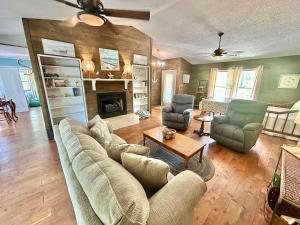 a living room with a couch and chairs and a fireplace at Our Anchor-Beach access, 3 BR, pet friendly in St. George Island