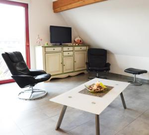 Televiisor ja/või meelelahutuskeskus majutusasutuses La maison du Vignoble
