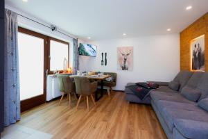 a living room with a couch and a table at Ferienwohnung Mankei in Schönau am Königssee