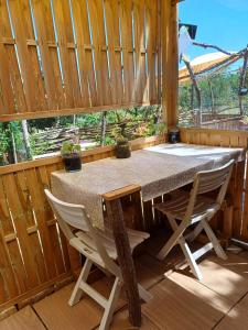 a table and chairs in a room with a window at TENTES sur une aire privée en pleine nature in Massillargues-Attuech +21 photos