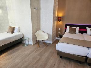 Postel nebo postele na pokoji v ubytování ATN Hôtel