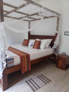 Ένα ή περισσότερα κρεβάτια σε δωμάτιο στο The Mango Villa