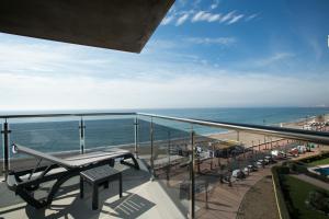 a balcony with a view of the beach and the ocean at Apartamentos Fuengirola Playa in Fuengirola