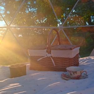 a basket and a cup on a table in a tent at Lunaria Manziana in Sambuco +4 photos