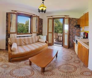 a living room with a couch and a table at Lela Kaptani Eftalou Olive Grove in Mythimna