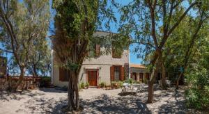 an exterior view of a house with trees at Lela Kaptani Eftalou Olive Grove in Mythimna