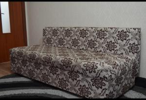 a gray and white couch sitting in a room at Назарбаева 19А уютная квартира в центре смарт тв wi-fi in Karagandy