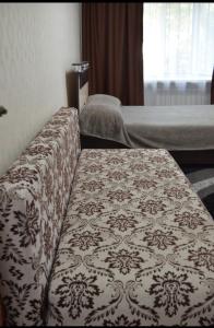 a bed room with two beds and a table at Назарбаева 19А уютная квартира в центре смарт тв wi-fi in Karagandy