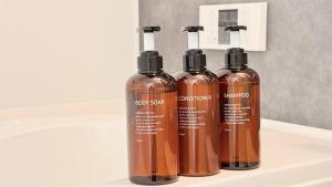 three brown bottles sitting on top of a shelf at Resort Villa YOFUKE in Yofuke