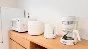 a counter with two coffee makers and a microwave at Resort Villa YOFUKE in Yofuke