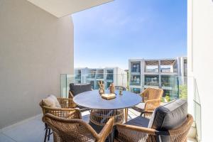 a patio with a table and chairs on a balcony at Artion Suites Nikiti in Nikiti