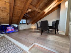 a dining room with a table and chairs and wooden ceilings at 039 Lussuoso trilocale, Pinzolo in Pinzolo