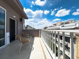 a balcony with a chair and a view at Palama Urban Vibes by ProLiving Hospitality in Thessaloniki