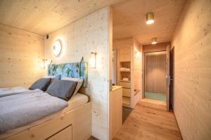 a bedroom in a log cabin with a bed at Berglodge37 in Altdorf +31 photos