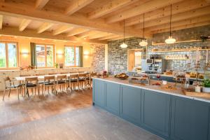 a large kitchen with a bar and a dining area at Berglodge37 in Altdorf