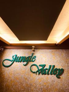 a sign that says jingle anxiety on a wall at JUNGLE VALLEY AYURVEDIC SPa RESORT in Meppādi
