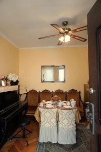 a dining room with a table and a ceiling fan at Luna in Kutaisi +11 photos