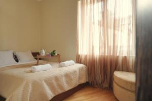 a bedroom with two beds and a window at Luna in Kutaisi