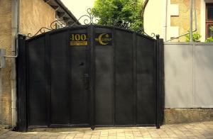 a black gate with a sign on it at Luna in Kutaisi