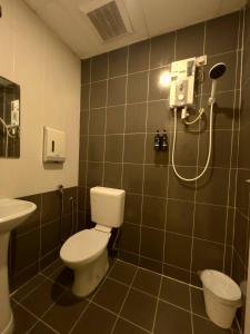a bathroom with a toilet and a shower at Hotel Istanaku , Ipoh, Perak in Ipoh