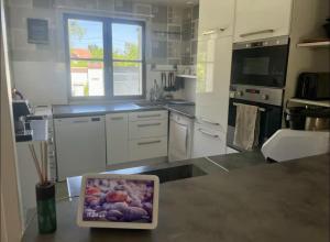 a tablet computer sitting on a counter in a kitchen at Maison avec jaccuzi in Achères-la-Forêt