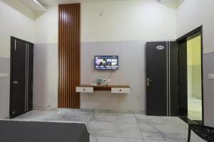 a hotel lobby with a tv on the wall at Hotel Sapphire in Narwāna +20 photos