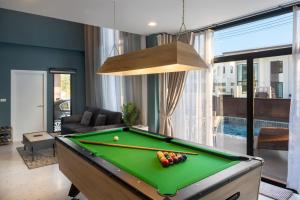 a living room with a pool table at Kanna Pool Villa in Chiang Mai