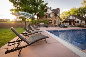 a group of chairs and an umbrella next to a pool at The Beatrice Estate estate in Grand Junction