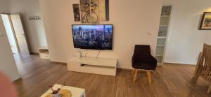 a living room with a tv on a wall at Apartment Magdalena in Sveti Filip i Jakov